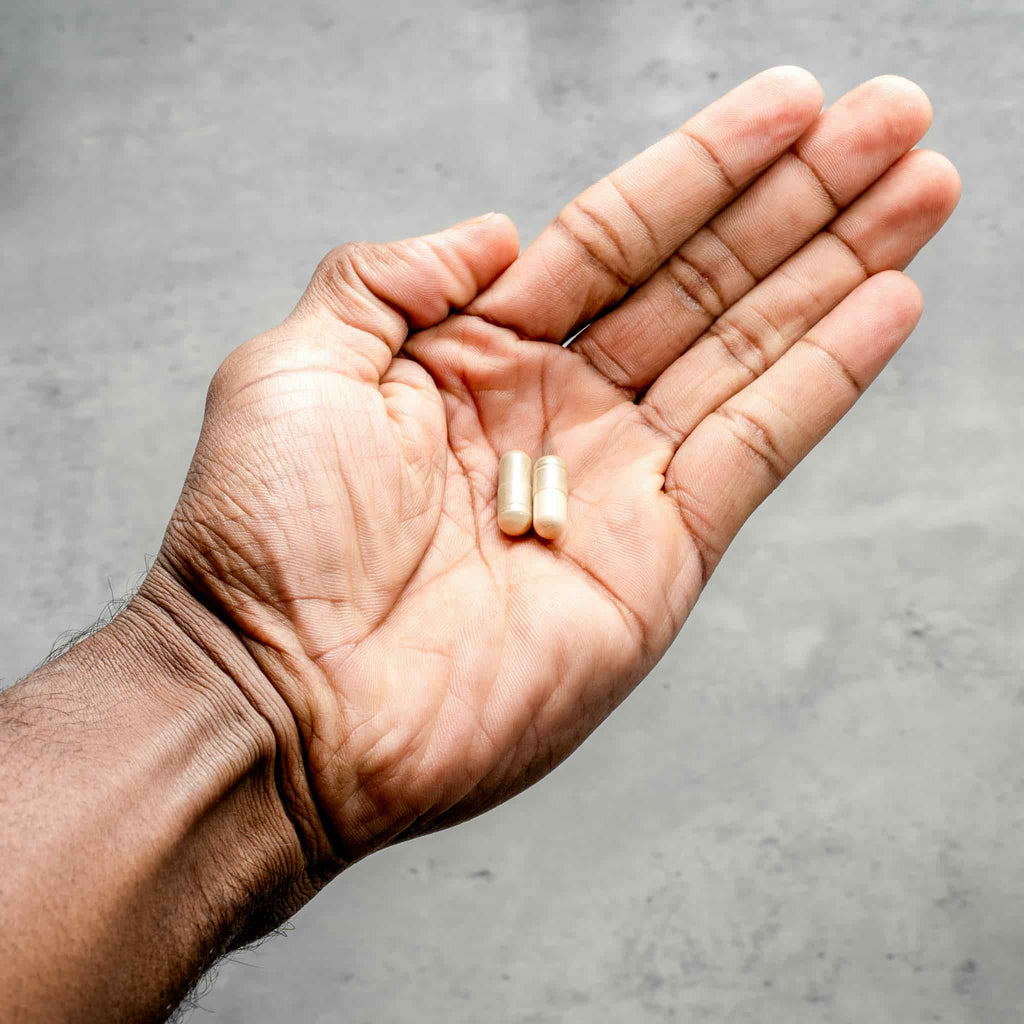  Two capsules in hand of male enhancement supplements