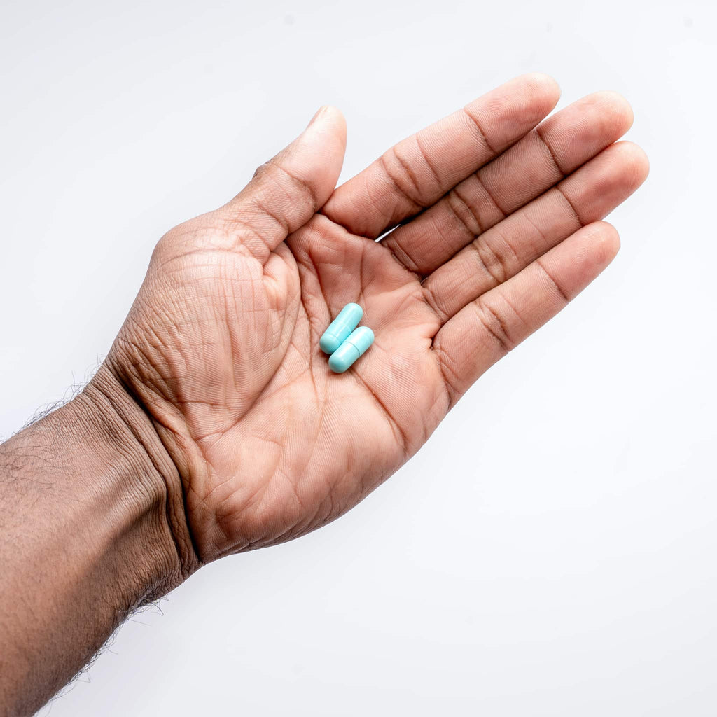 two capsules in hand of golden root compound